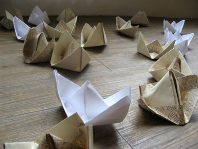 Close-up of origami boat installation